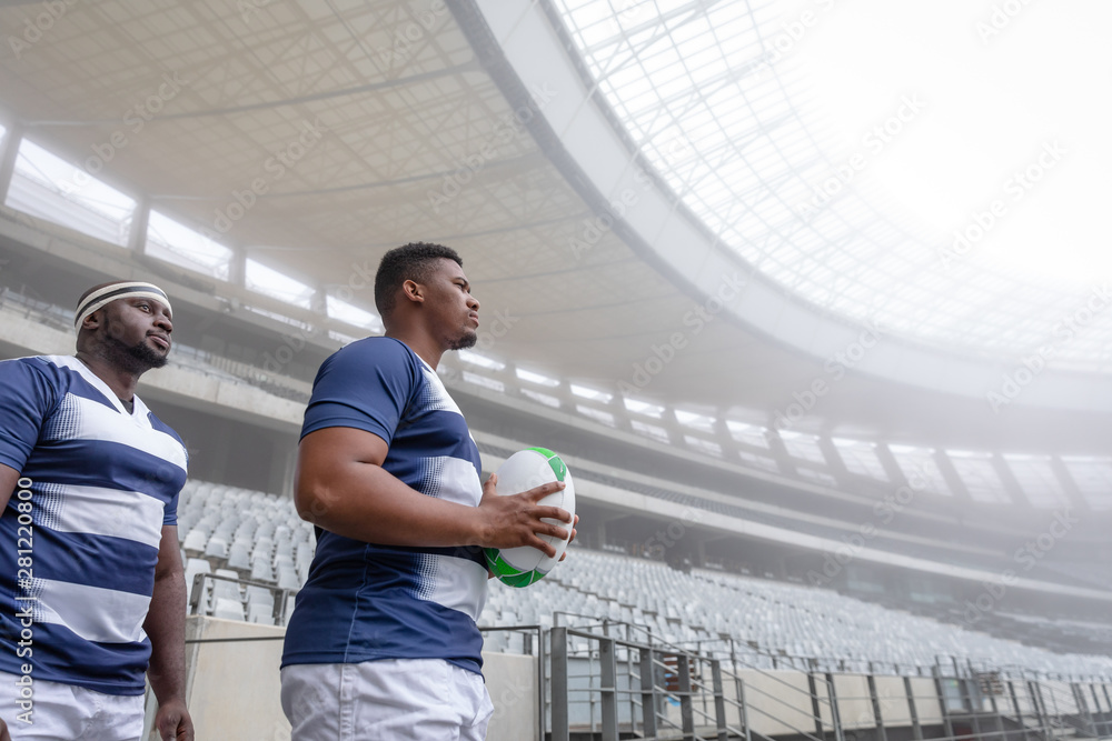 Diverse male rugby player standing in a row at the entrance of stadium Diverse male rugby player standing in a row at the entrance of stadium