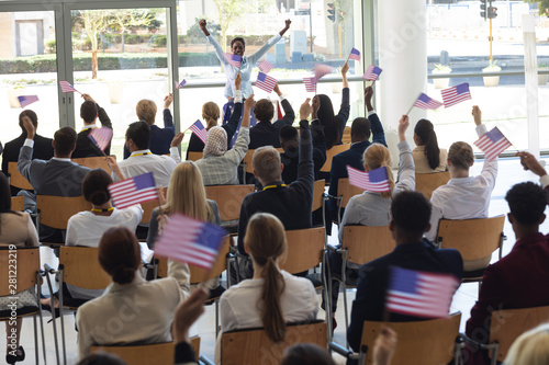 Young businesswoman doing speech and celebrating victory in conference room