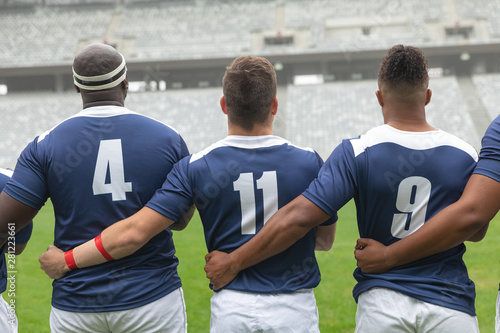 Diverse Male rugby players taking pledge together in stadium