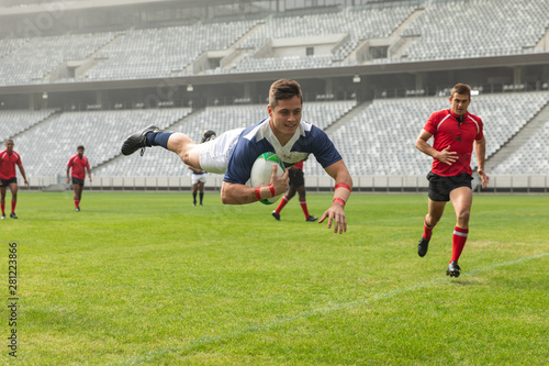 Group of diverse male rugby players playing rugby in stadium