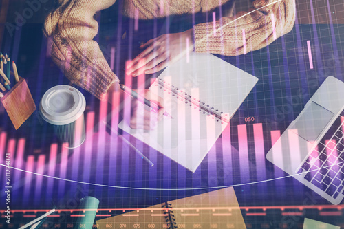 Forex graph on hand taking notes background. Concept of research. Double exposure