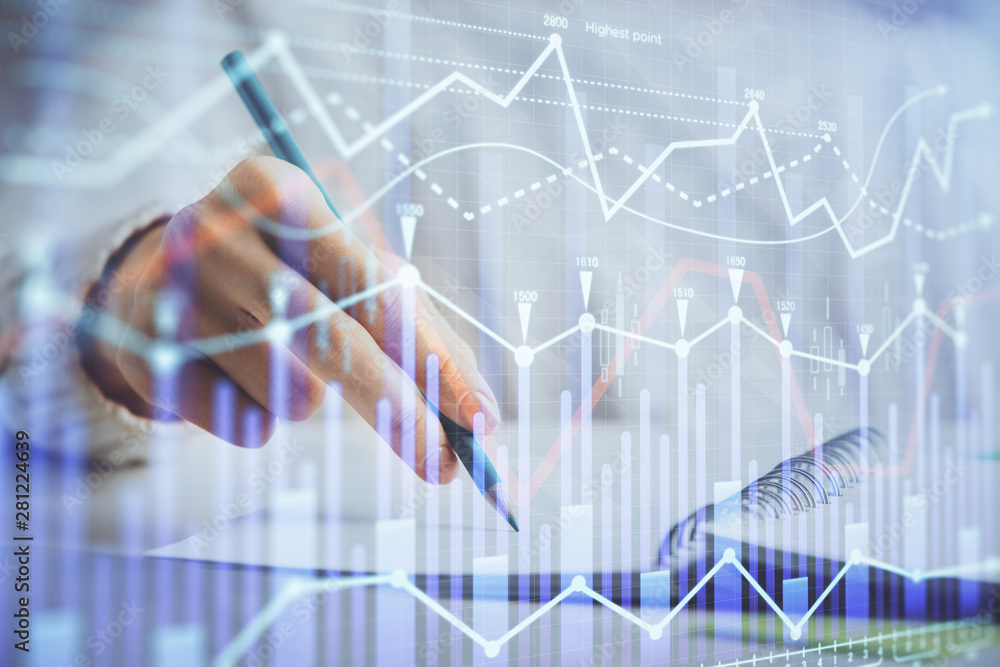 Financial forex graph displayed on hands taking notes background. Concept of research. Double exposure Financial forex graph displayed on hands taking notes background. Concept of research. Double exposure