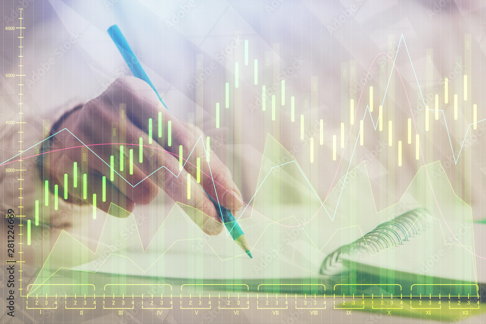 Financial forex graph displayed on hands taking notes background. Concept of research. Double exposure Financial forex graph displayed on hands taking notes background. Concept of research. Double exposure