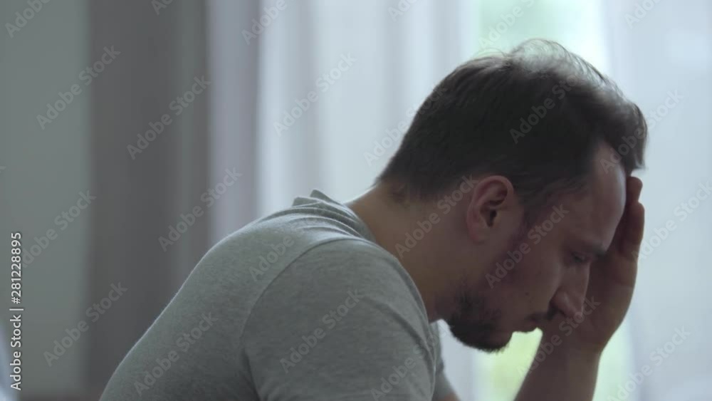 Portrait of stressed man at home. Problems in the relationships. Betrayal, mistrust, breakup concept. The man in depression. Restless man having problems in personal life suffers break up. Portrait of stressed man at home. Problems in the relationships. Betrayal, mistrust, breakup concept. The man in depression. Restless man having problems in personal life suffers break up.