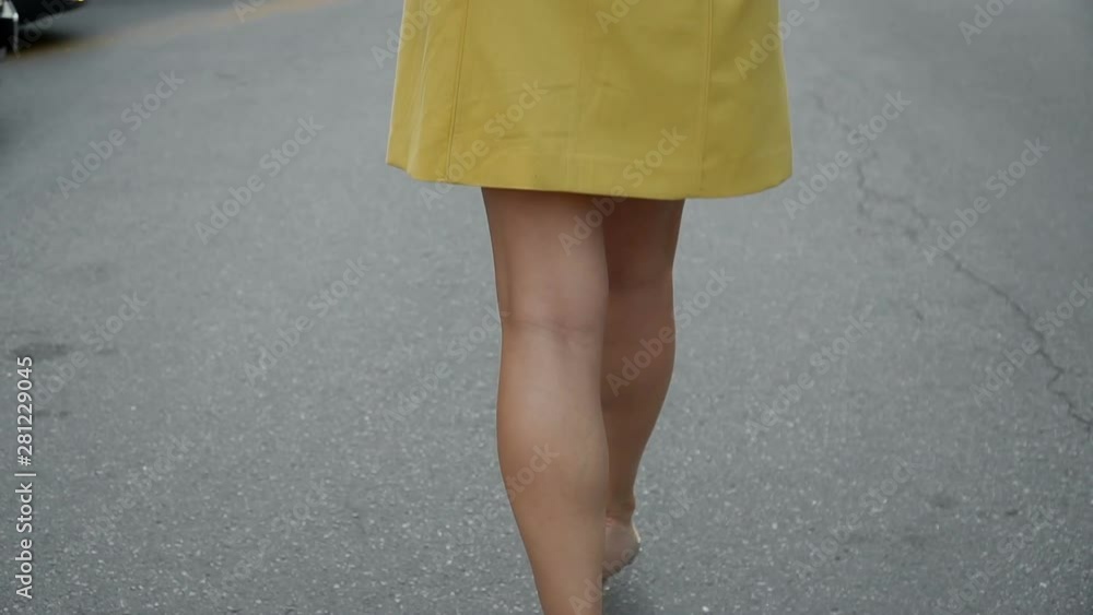 Woman's legs in high heel shoes walking on road slow motion. Woman's legs in high heel shoes walking on road slow motion.