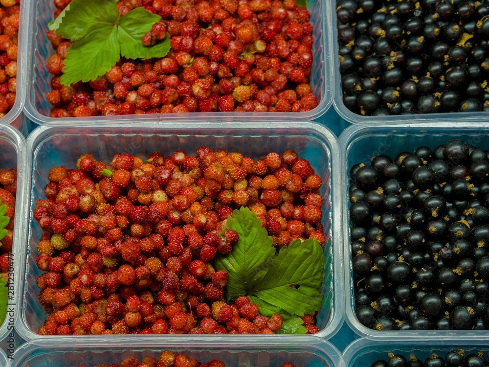 small strawberries in a plastic box at marketplace showcase small strawberries in a plastic box at marketplace showcase