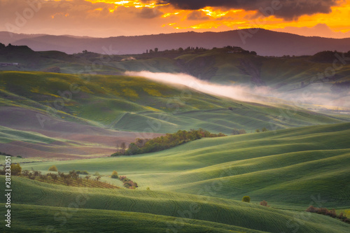 Fantastic sunny spring field in Italy, tuscany landscape morning foggy famous Cypress trees photo