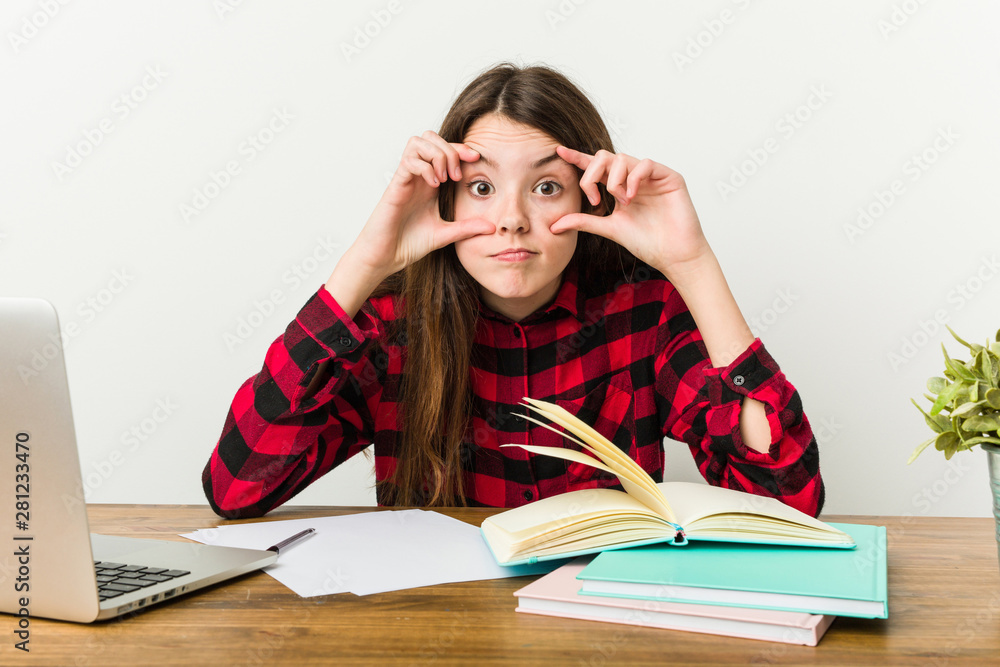 Young teenager going back to her routine doing homeworks keeping eyes opened to find a success opportunity. Young teenager going back to her routine doing homeworks keeping eyes opened to find a success opportunity.