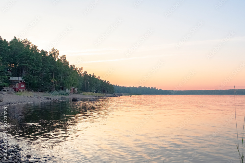 Finland, northern Europe, the rocky shore of the lake. Sunset and natural landscape