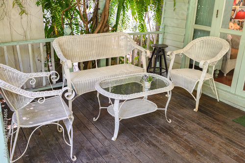 Antique weaving chairs with table on wood patio