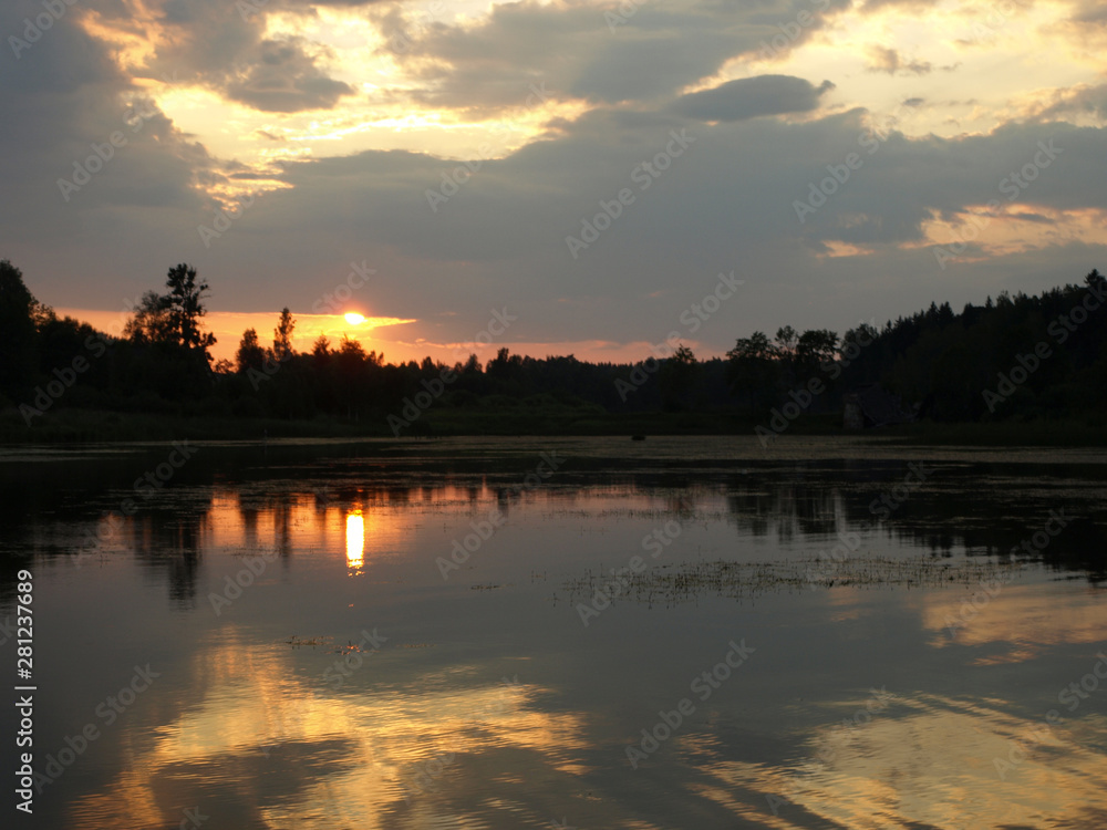 Naklejka premium beautiful sun set on calm lake, red sun, calm lake, quiet evening, Latvia