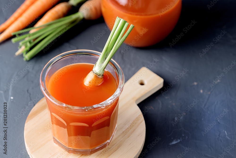 Fresh Carrot Juice in a Glass on a Dark Grey Background Healthy Drink Detox Diet Juice Glass of Tasty Carrot Juice on Wooden Board Above