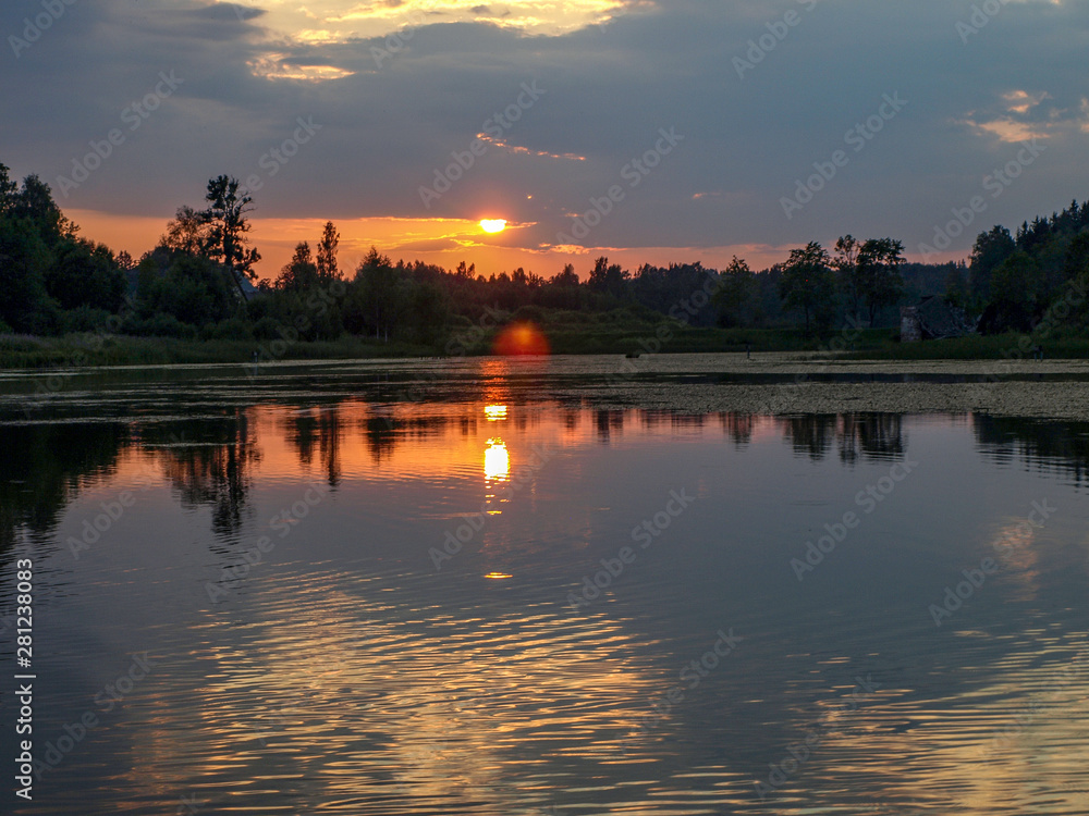 Naklejka premium beautiful sun set on calm lake, red sun, calm lake, quiet evening, Latvia