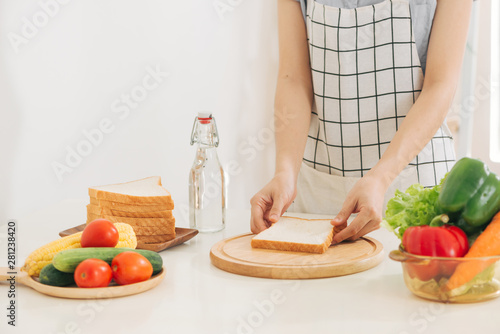 happy young mother  preparing snacks in the morning at home kitchen