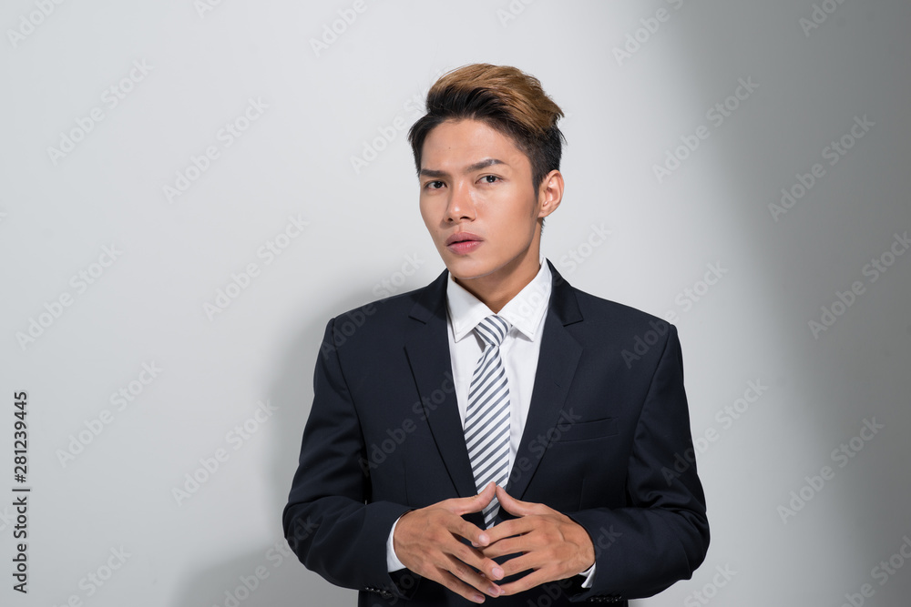 Portrait of young and handsome Asian business man holding a jacket isolated on white background Portrait of young and handsome Asian business man holding a jacket isolated on white background