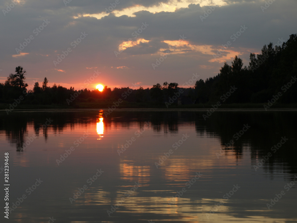 Obraz premium beautiful sun set on calm lake, red sun, calm lake, quiet evening, Latvia
