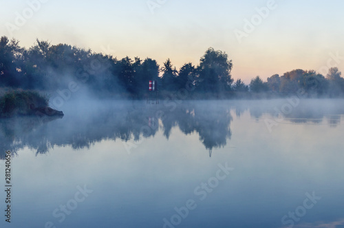 Morning landscape with fog over the lake © andrei310