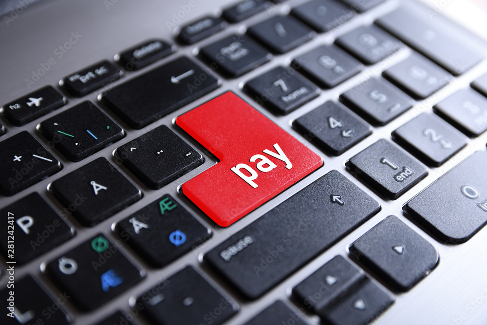Close-up view on conceptual notebook keyboard - pay (red key,button) Close-up view on conceptual notebook keyboard - pay (red key,button)