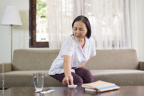 Elderly asian women having painful at home,Senior female suffering from abdominal pain