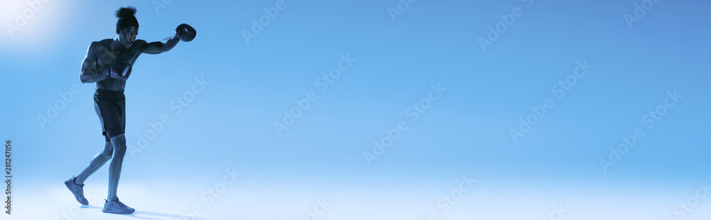 panoramic shot of shirtless african american sportsman boxing on blue background panoramic shot of shirtless african american sportsman boxing on blue background