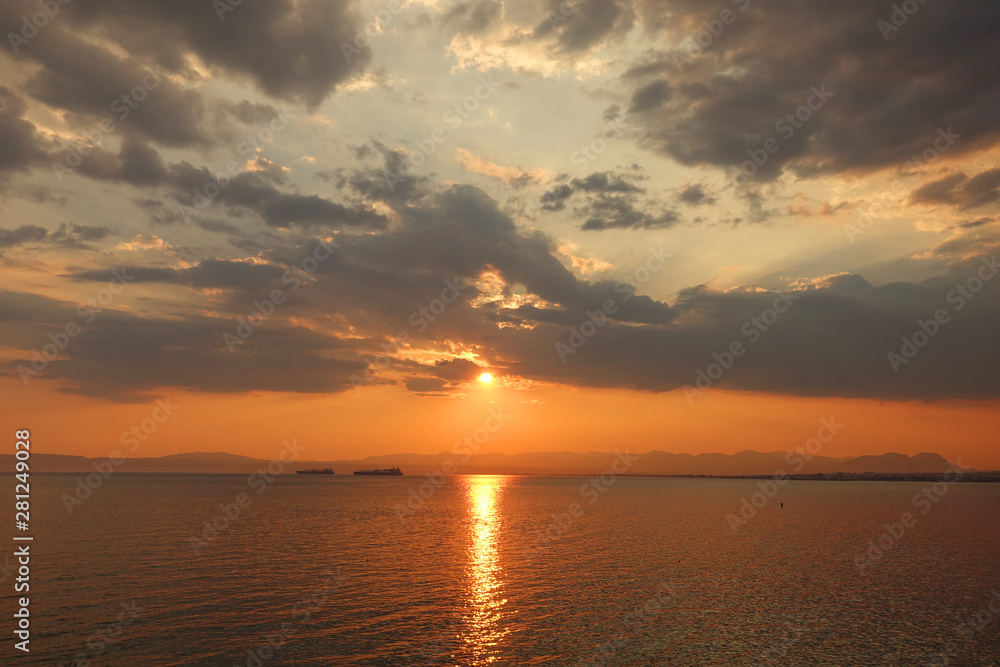 Beautiful sunset with clouds over the Aegean sea