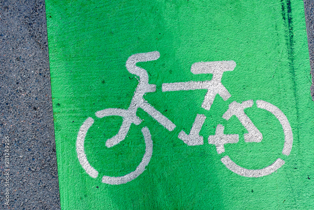 Cycle path in the city, green sign on asphalt Cycle path in the city, green sign on asphalt