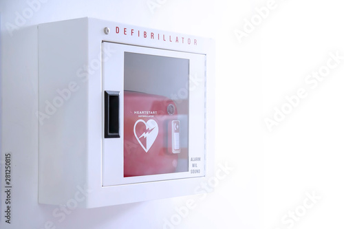 Automated External Defibrillator (AED) in white box on the wall Is an emergency pacemaker device for people with cardiac arrest. Heart defibrillator on white background.