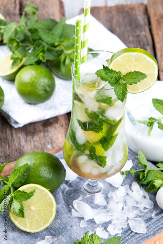Mohito lime drinks on wooden with blur beach background