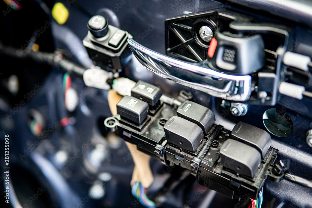 Car interior door handle and mirror button control panel without cover material inside of the racing car. Automobile industry concept Car interior door handle and mirror button control panel without cover material inside of the racing car. Automobile industry concept