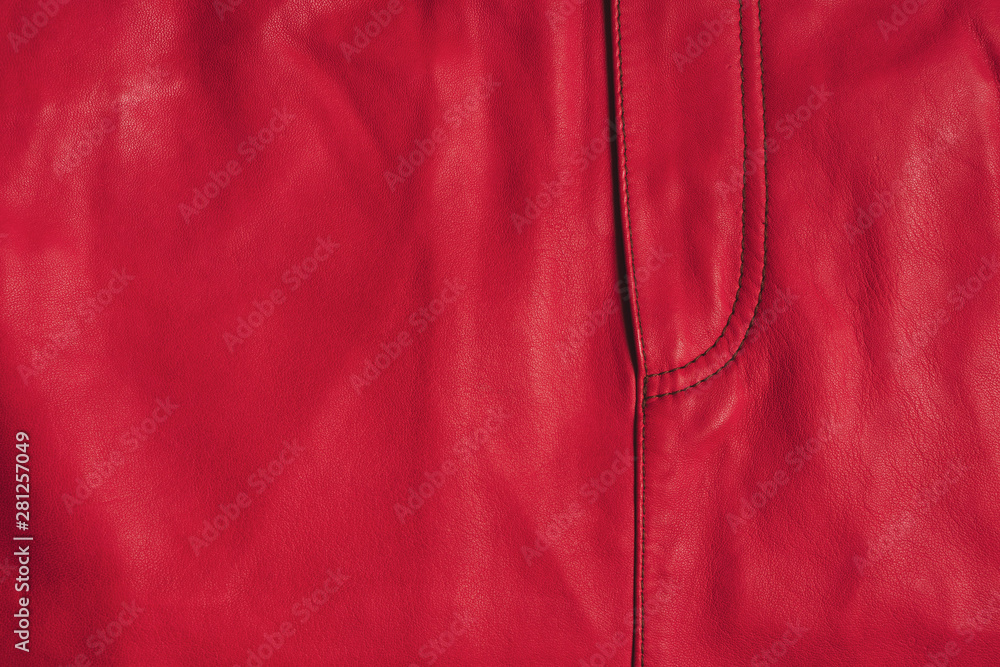 Red leather skirt texture. Stitched skirt front side with copy space. Closeup texture background. Red leather skirt texture. Stitched skirt front side with copy space. Closeup texture background.