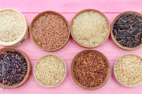 Assortment of different rice in bowls: white rice red rice black rice a mixture of wild and brown rice. The whole grain of rice. unpolished rice. Healthy food background.