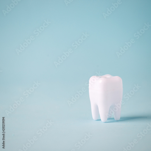Fototapeta Naklejka Na Ścianę i Meble -  Dental care concept, Healthy tooth model on blue background with copy space. Minimal dentistry, oral tooth hygiene concept
