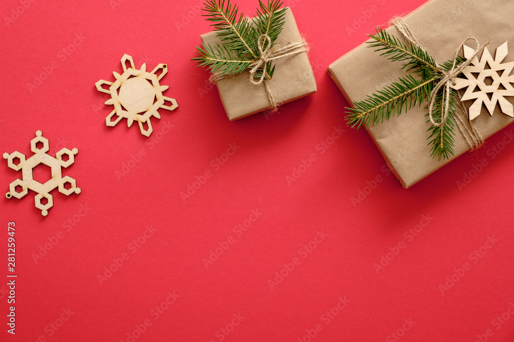 Handmade Christmas decorations and presents wrapped fir tree branches on red background. Flat lay, top view, copy space. Christmas, winter, New year concept. Greeting card template Handmade Christmas decorations and presents wrapped fir tree branches on red background. Flat lay, top view, copy space. Christmas, winter, New year concept. Greeting card template