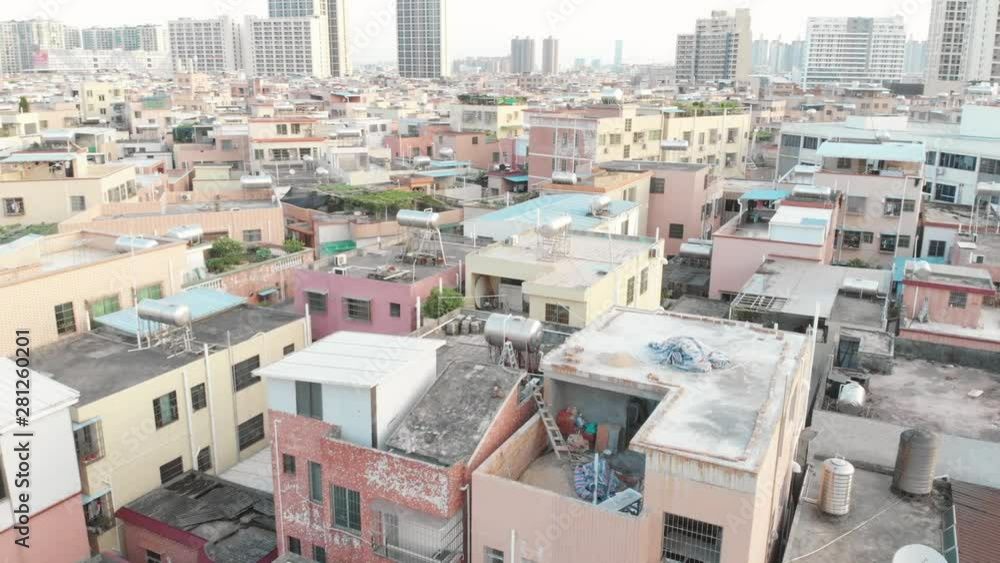 Flying drone low over the roofs of a densely built area for the poor. Houses are built randomly, very narrow streets. On the windows of the lattice, on the roofs of debris Flying drone low over the roofs of a densely built area for the poor. Houses are built randomly, very narrow streets. On the windows of the lattice, on the roofs of debris
