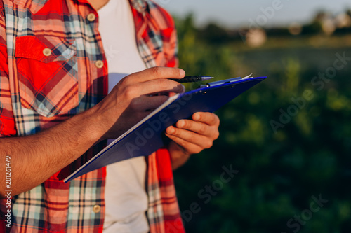 Close Up male hands holding paper documents with pen and writing a notes - Image