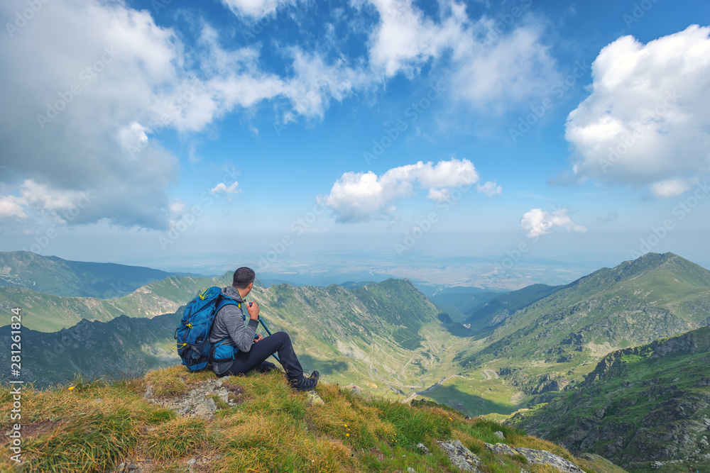 Successful active man hiker on top of mountain enjoying the view. Travel sport lifestyle concept