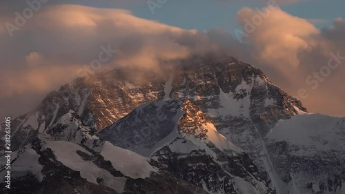 Time lapse of clouds moving over summit of Mount everest at sunset photo