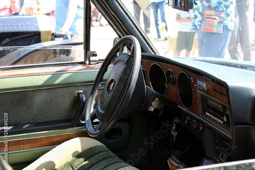 View of the steering wheel and cockpit dashboard in vintage style. Retro car.