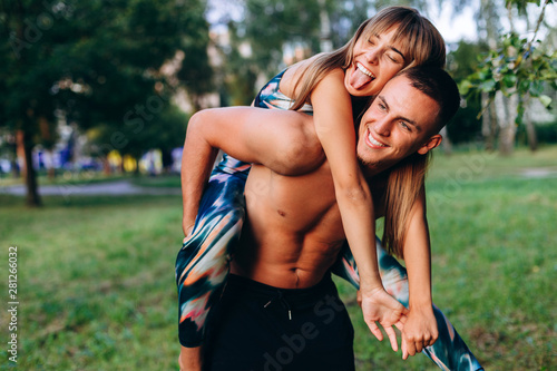 Couple man and woman have a fun time in the park outdoor