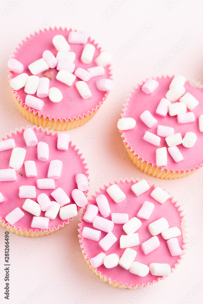 Colorful cupcakes on a pink background. Colorful cupcakes on a pink background.