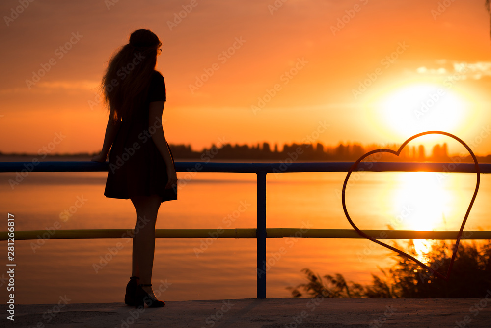 silhouette of carefree woman in sunset on beach. vacation vitality healthy living concept