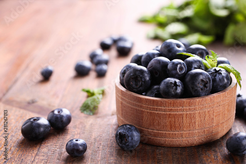 Ripe Fresh Blueberries in wooden bowl