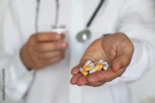 Doctor giving pills, physician with medication in capsules. Concept of dose of drugs, vitamins, medical exam, pharmacy, flu treatment
