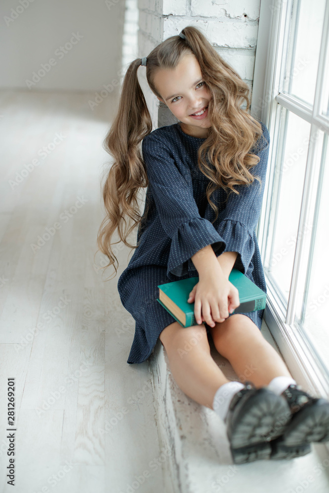 Girl schoolgirl reads a book. School fashion. Fashionable school uniform. Girl schoolgirl reads a book. School fashion. Fashionable school uniform.