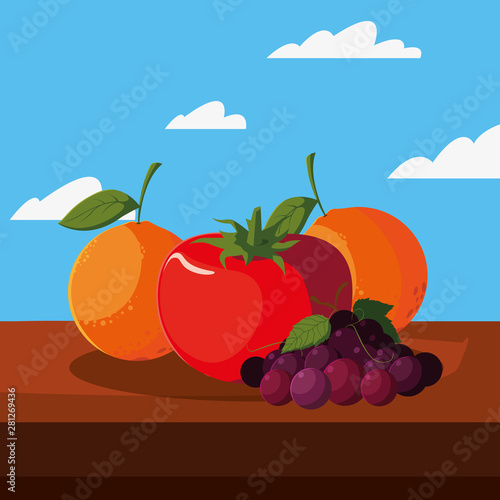 fresh fruit tomato orange grapes on table outdoors