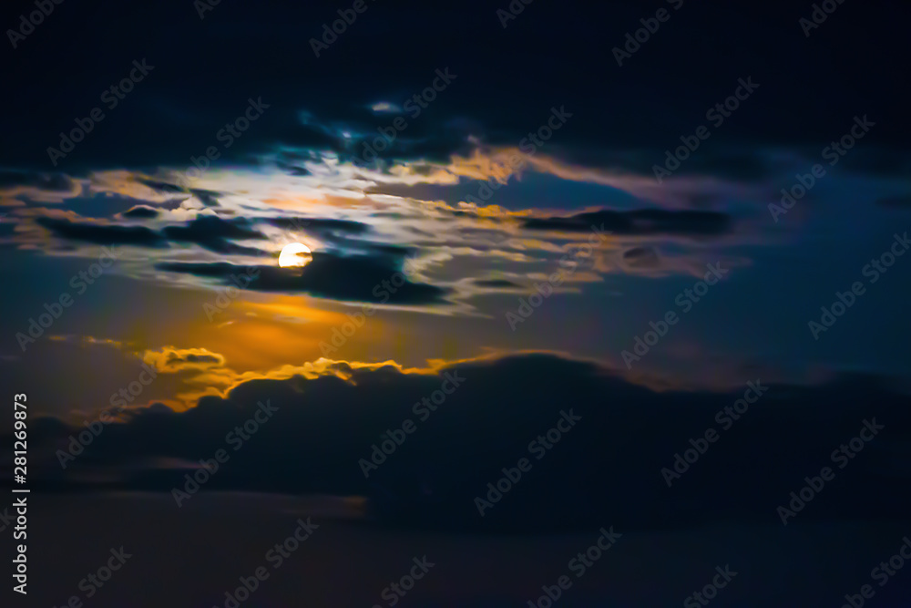 Night sky with moon and clouds.