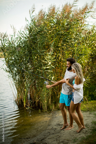 Young couple enjoying fishi...