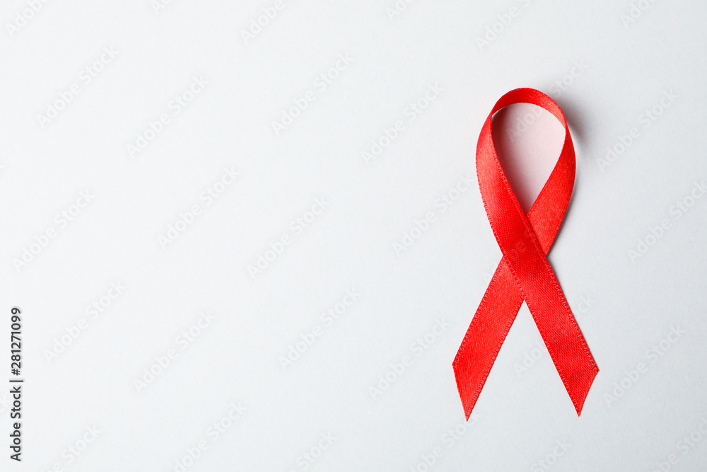 Red awareness ribbon on red background, space for text Red awareness ribbon on red background, space for text