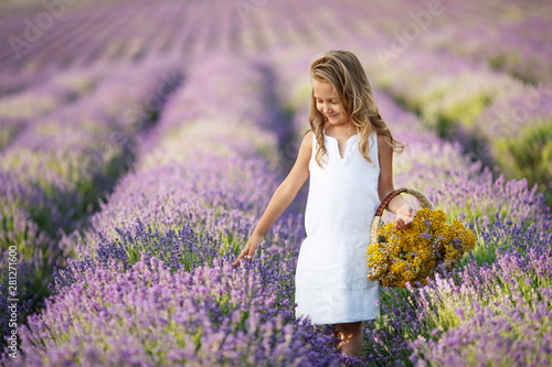 A child in a field with flowers. Teen girl in a lavender field. Happy child in nature. 