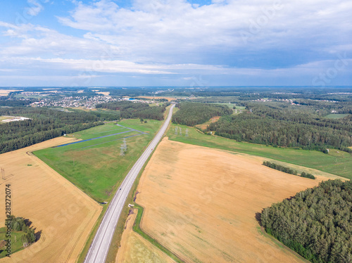 Fields. They harvest wheat and rye, collected in stacks. Photo from quadcopter. Autumn harvest. The concept of modern agriculture. Sky view.